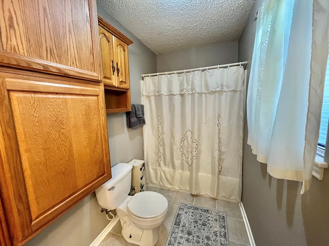 670 Cedar Crest Cir, Hemphill, TX 75948 - full bathroom featuring toilet, tile patterned floors, baseboards, a textured ceiling, and shower / bath combination with curtain