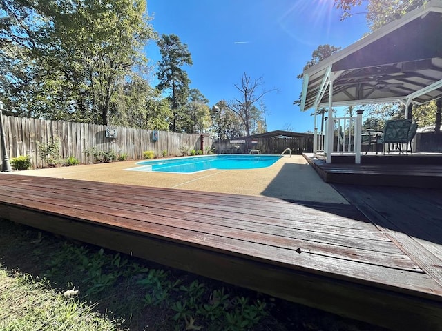 670 Cedar Crest Cir, Hemphill, TX 75948 - view of swimming pool with a fenced backyard, ceiling fan, a wooden deck, and a gazebo