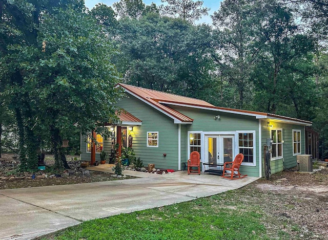 view of front of house featuring central AC and french doors