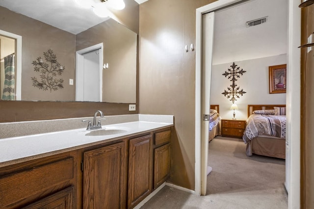 bathroom featuring vanity, connected bathroom, and visible vents