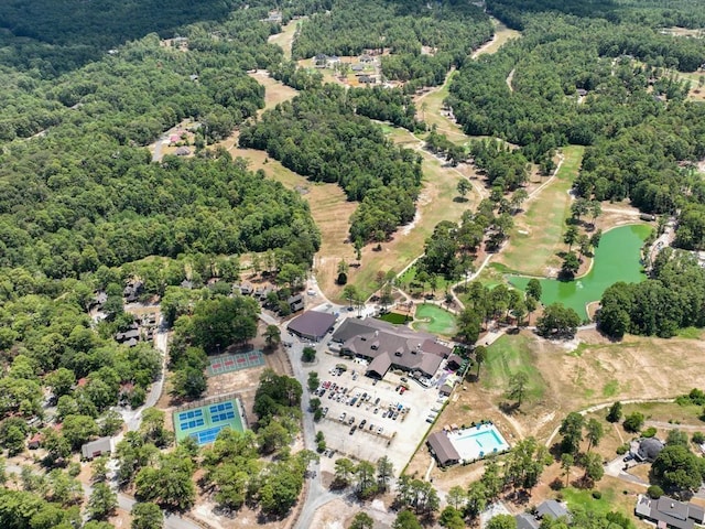 drone / aerial view featuring a water view and a wooded view