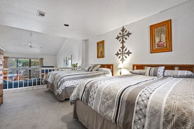 bedroom with vaulted ceiling, carpet floors, and visible vents