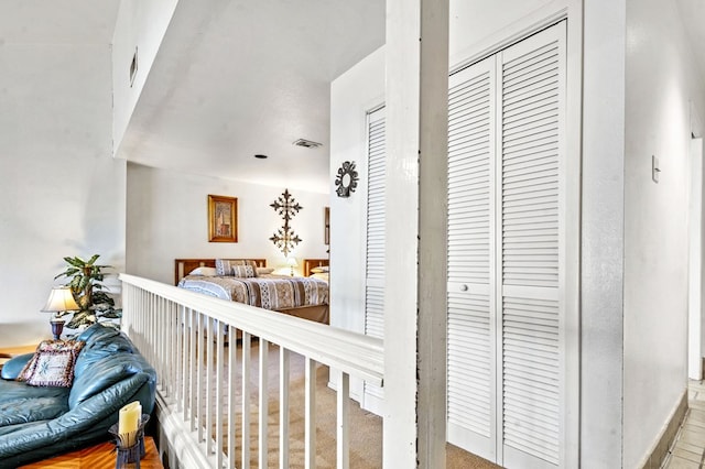 bedroom with vaulted ceiling, carpet floors, and visible vents