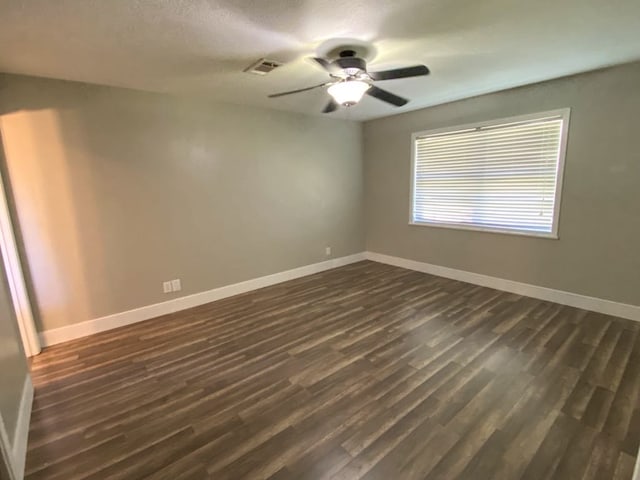 spare room with dark hardwood / wood-style flooring and a textured ceiling