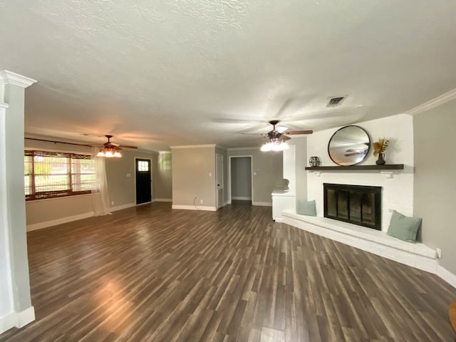 unfurnished living room with a textured ceiling, dark hardwood / wood-style floors, ceiling fan, and ornamental molding