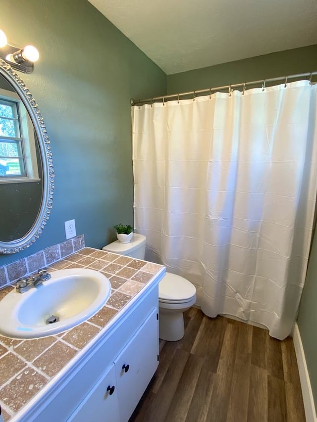 bathroom with hardwood / wood-style floors, vanity, and toilet