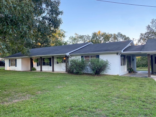 ranch-style house featuring a front yard and a carport