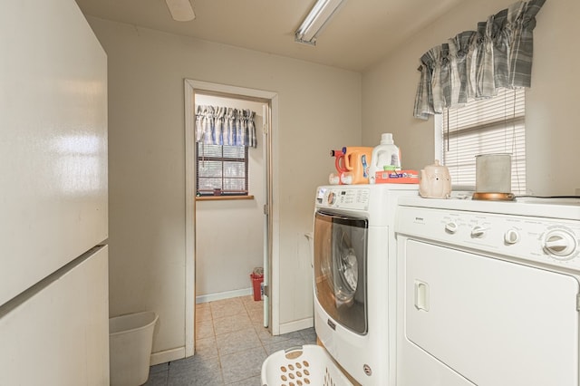 1500 New Haven Rd, Hemphill, TX 75948 - laundry area featuring washer and clothes dryer, a healthy amount of sunlight, and light tile patterned flooring