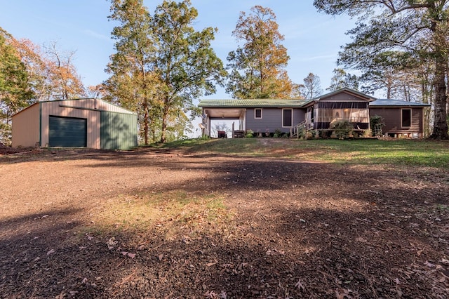 1500 New Haven Rd, Hemphill, TX 75948 - rear view of house with a garage, an outdoor structure, and a sunroom