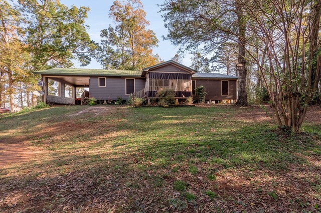 1500 New Haven Rd, Hemphill, TX 75948 - back of property with a lawn, a sunroom, and a carport