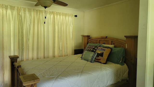 bedroom with ceiling fan and ornamental molding