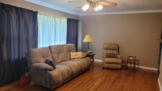 living room featuring hardwood / wood-style floors, ceiling fan, ornamental molding, and a textured ceiling