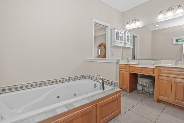 bathroom with tile patterned flooring, vanity, and tiled bath