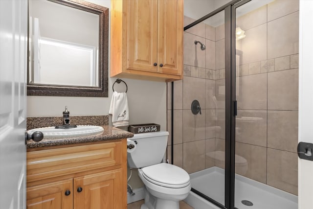 bathroom with vanity, toilet, and walk in shower