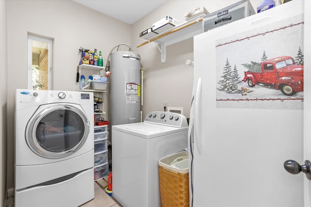 washroom with water heater, washer and dryer, and light tile patterned floors