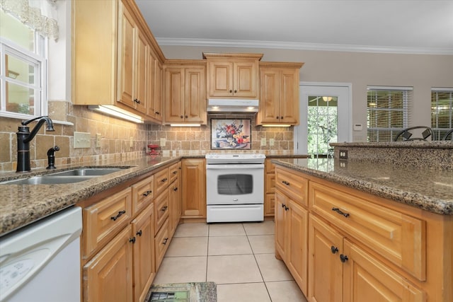 kitchen featuring sink, white appliances, light tile patterned flooring, and stone countertops