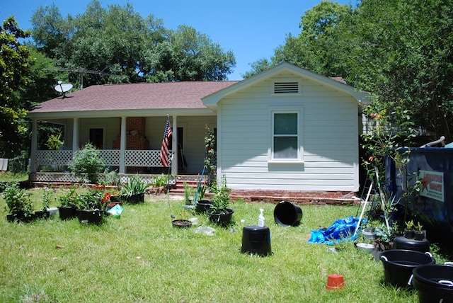 view of front of property with a front yard and covered porch