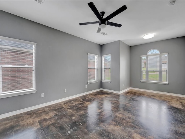 empty room with ceiling fan and dark wood-type flooring