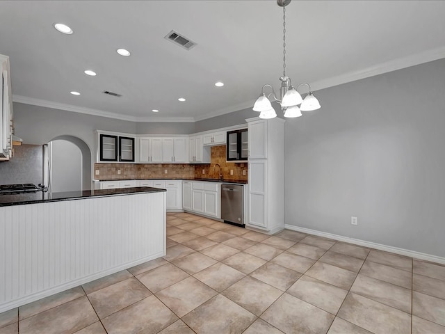 kitchen featuring pendant lighting, decorative backsplash, white cabinetry, and appliances with stainless steel finishes