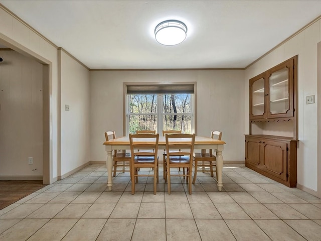 tiled dining room with ornamental molding