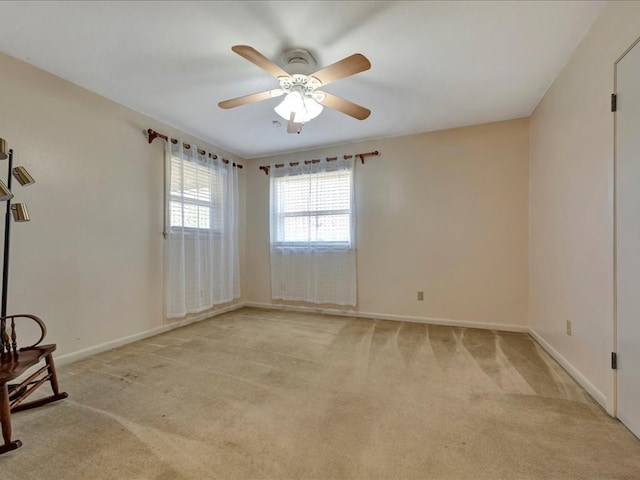 empty room with ceiling fan and light carpet