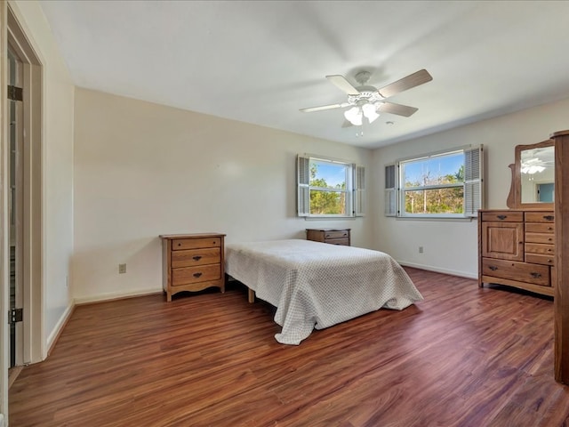 bedroom with dark hardwood / wood-style floors and ceiling fan