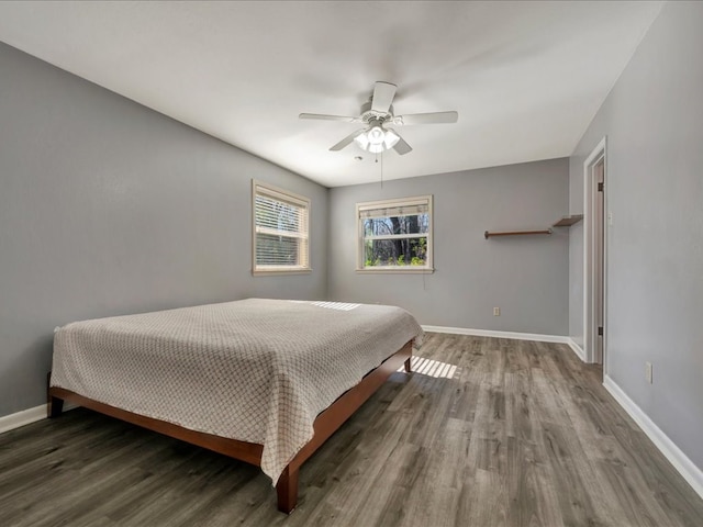 bedroom featuring dark hardwood / wood-style floors and ceiling fan