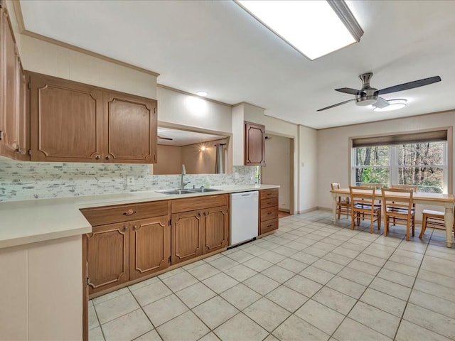 kitchen featuring ceiling fan, dishwasher, sink, tasteful backsplash, and light tile patterned floors