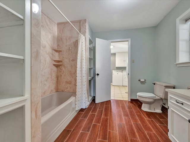 full bathroom featuring vanity, washer and dryer, toilet, and shower / tub combo