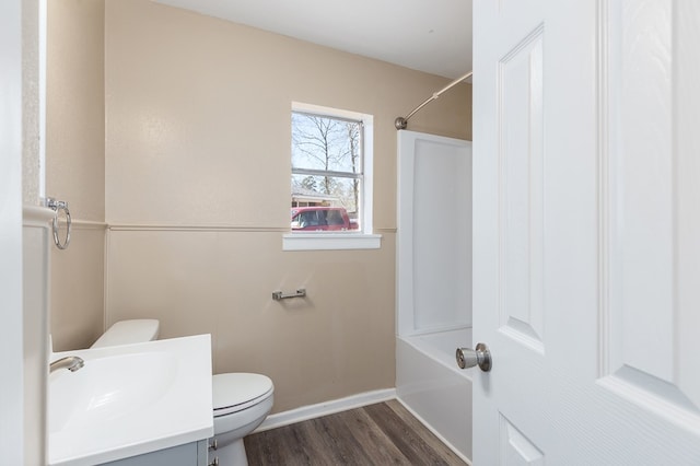 full bathroom with shower / bath combination, vanity, hardwood / wood-style floors, and toilet