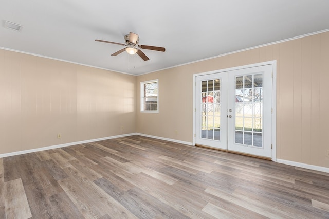 unfurnished room featuring crown molding, light hardwood / wood-style floors, french doors, and ceiling fan