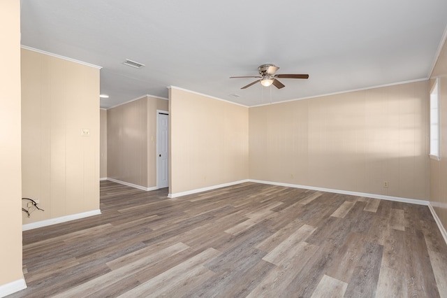 spare room with hardwood / wood-style flooring, crown molding, and ceiling fan