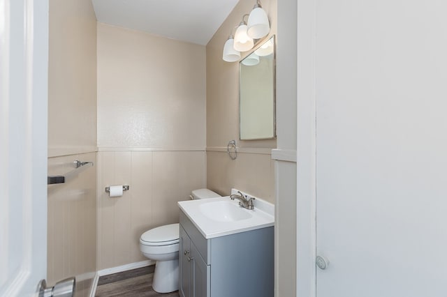 bathroom featuring hardwood / wood-style flooring, vanity, and toilet