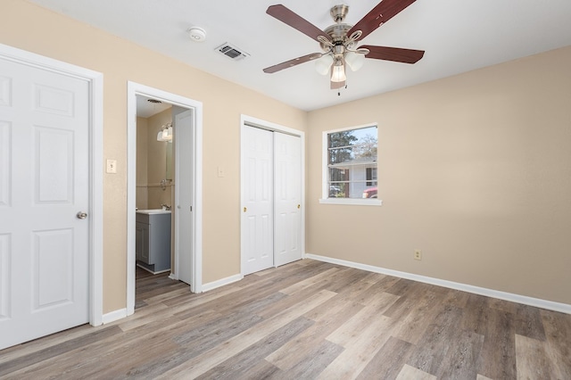 unfurnished bedroom featuring a closet, ceiling fan, and light hardwood / wood-style flooring