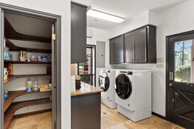 laundry room with cabinets, washing machine and dryer, electric panel, and a wealth of natural light