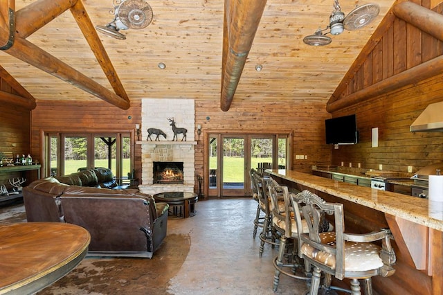 living room featuring french doors, high vaulted ceiling, and wooden walls