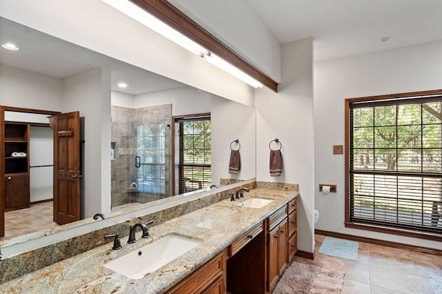 bathroom with vanity, toilet, and an enclosed shower