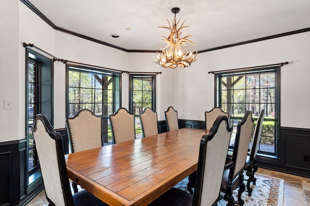 dining space with a chandelier and ornamental molding