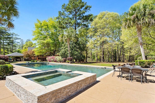 view of pool featuring a gazebo, an in ground hot tub, and a patio