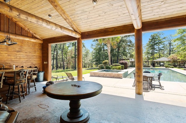 view of patio / terrace featuring a pool with hot tub