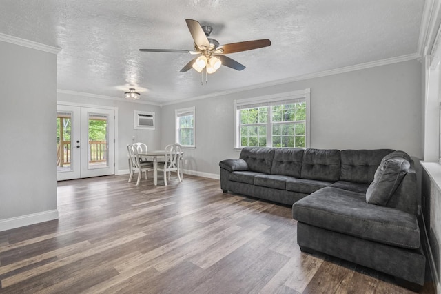 living room with ornamental molding, hardwood / wood-style floors, a textured ceiling, and french doors