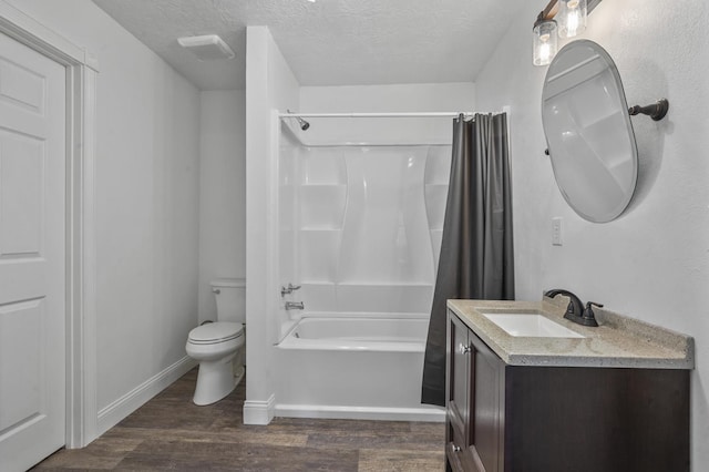 full bathroom with hardwood / wood-style flooring, toilet, a textured ceiling, and shower / bath combo with shower curtain