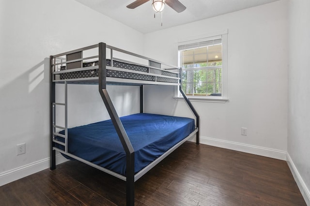 bedroom with dark hardwood / wood-style flooring and ceiling fan