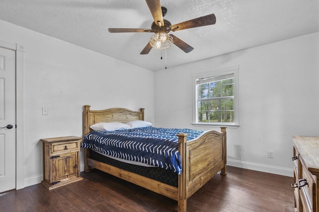 bedroom with a textured ceiling, dark hardwood / wood-style floors, and ceiling fan