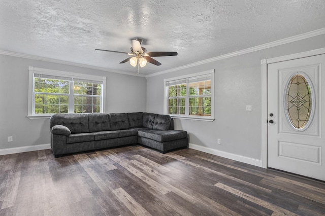 living room with dark hardwood / wood-style flooring, plenty of natural light, and ornamental molding