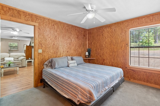 264 Wildbriar Dr, Jasper, TX 75951 - bedroom featuring carpet, ceiling fan, baseboards, and wooden walls