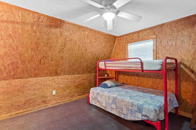 264 Wildbriar Dr, Jasper, TX 75951 - carpeted bedroom featuring wood walls and ceiling fan