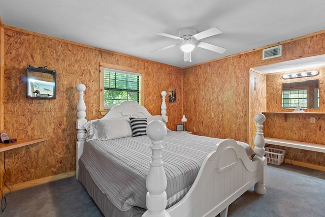 264 Wildbriar Dr, Jasper, TX 75951 - bedroom with wood walls, carpet flooring, and a ceiling fan