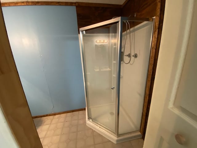 bathroom featuring a shower with door