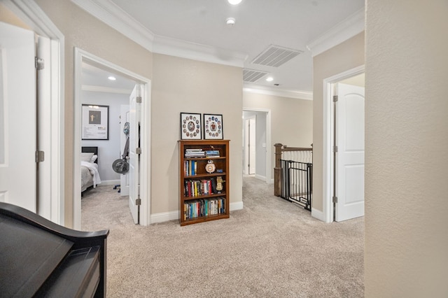 hallway featuring visible vents, carpet, an upstairs landing, and crown molding